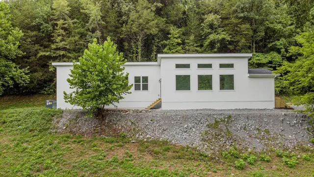 a front view of a house with a garden