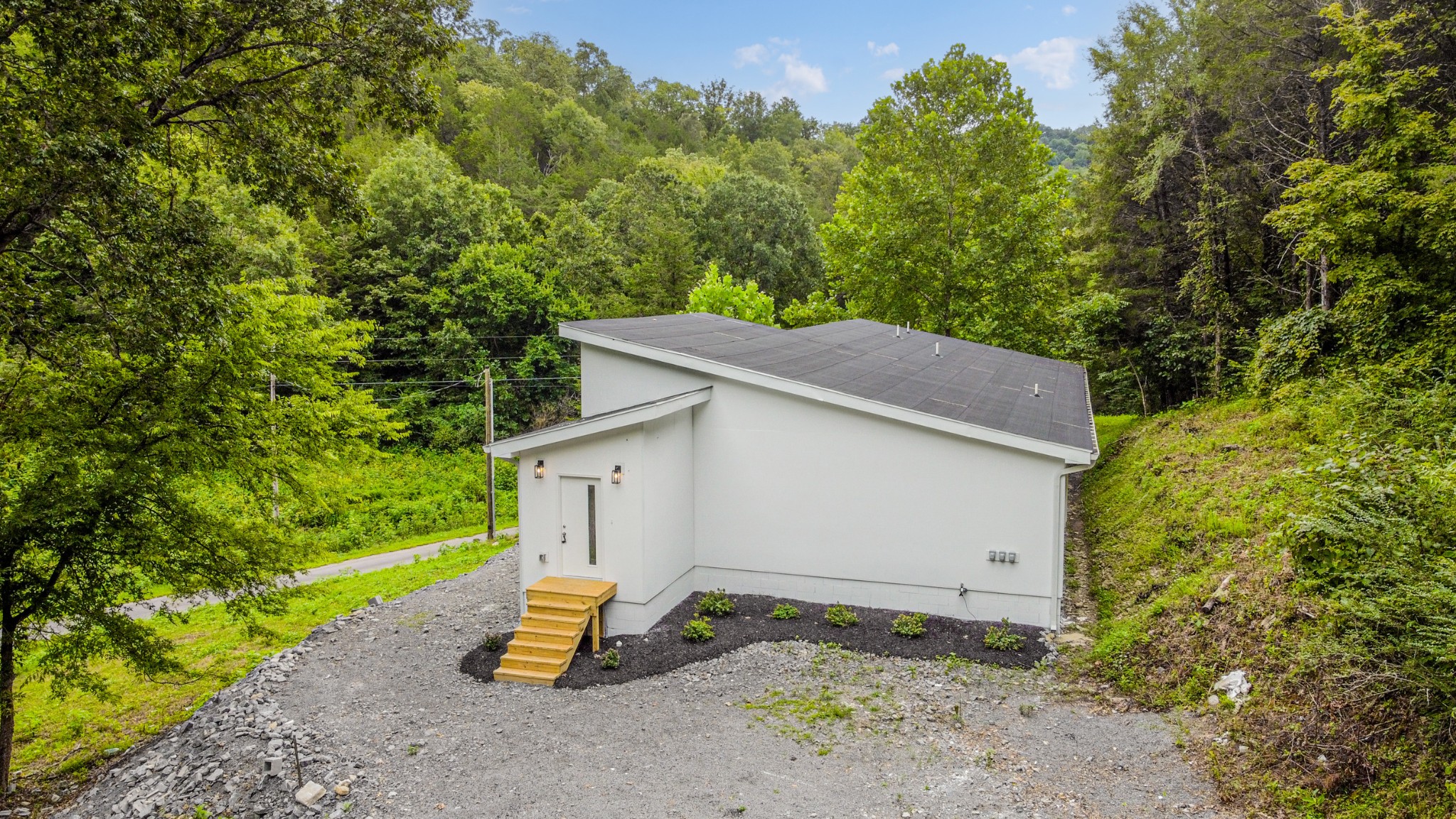 515 Big Branch Road Granville, TN 38564 - Photo 4 of 76 a backyard of a house with wooden fence and trees