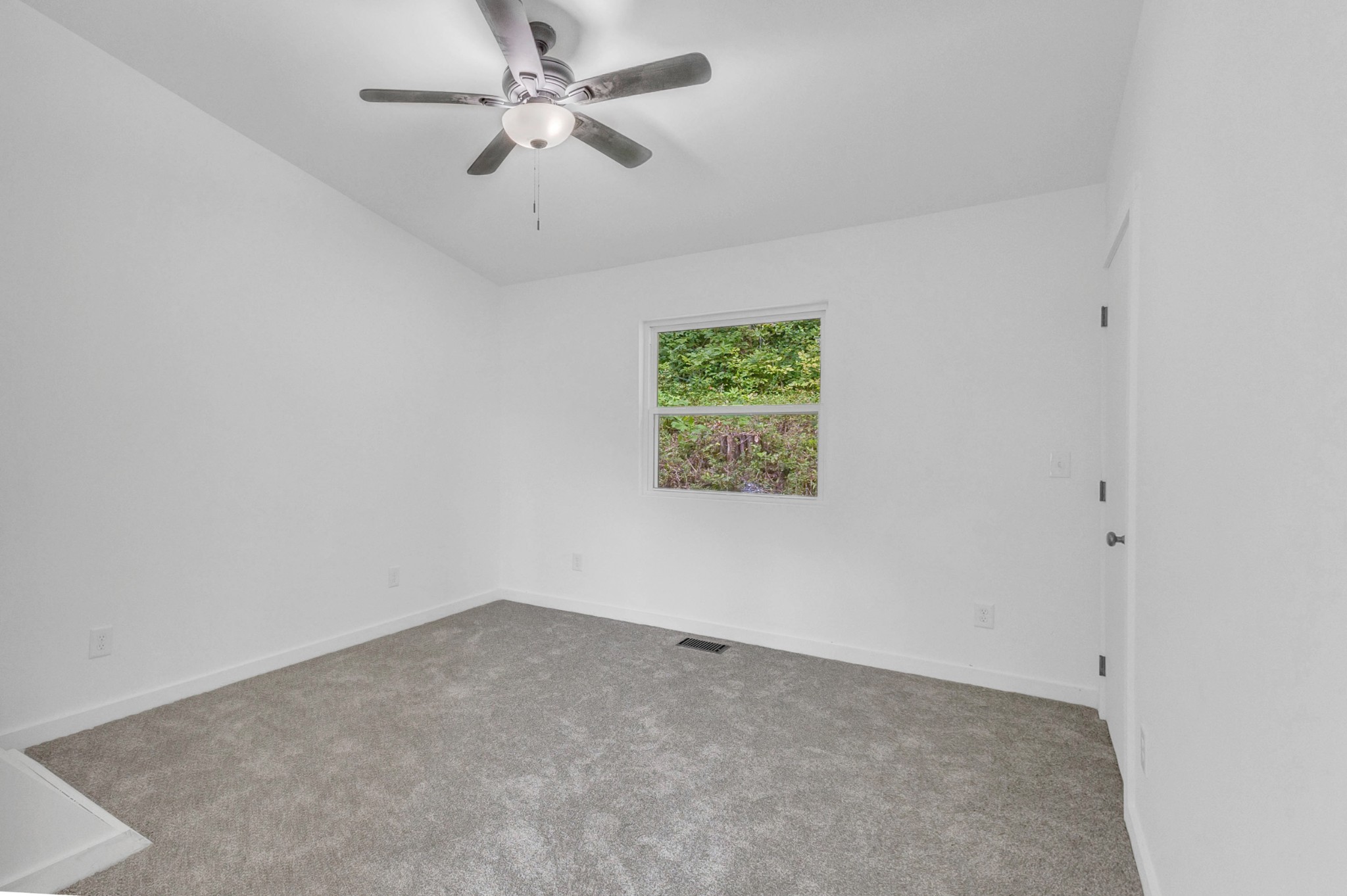 515 Big Branch Road Granville, TN 38564 - Photo 47 of 76 an empty room with a window and a ceiling fan