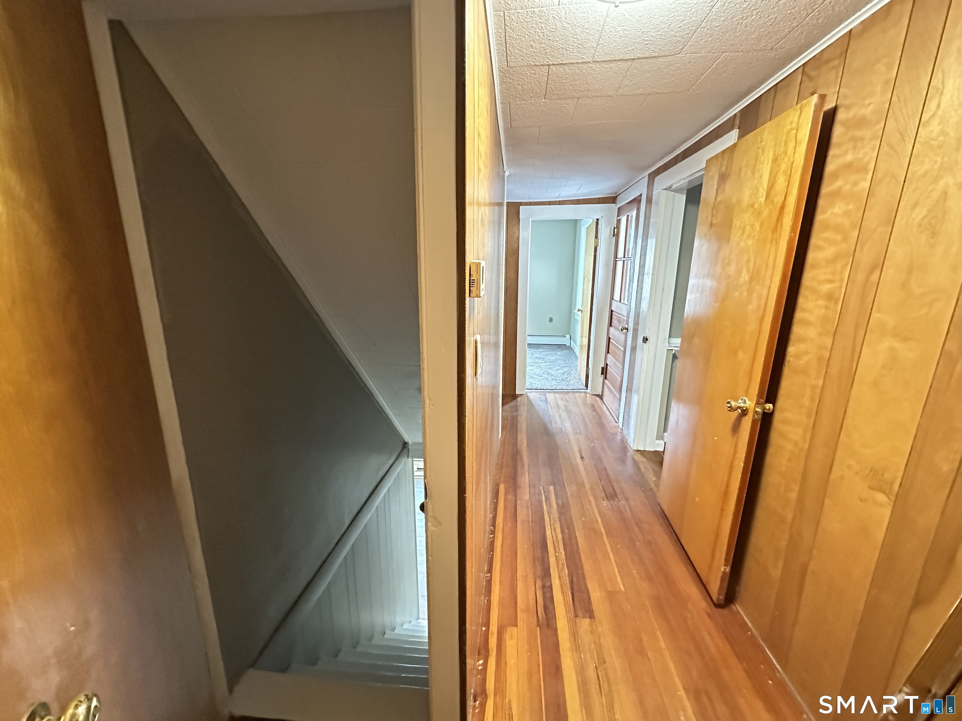 40 Oak Street, Unit 1 Windsor Locks, CT 06096 - Photo 10 of 21 a view of a hallway with wooden floor and staircase