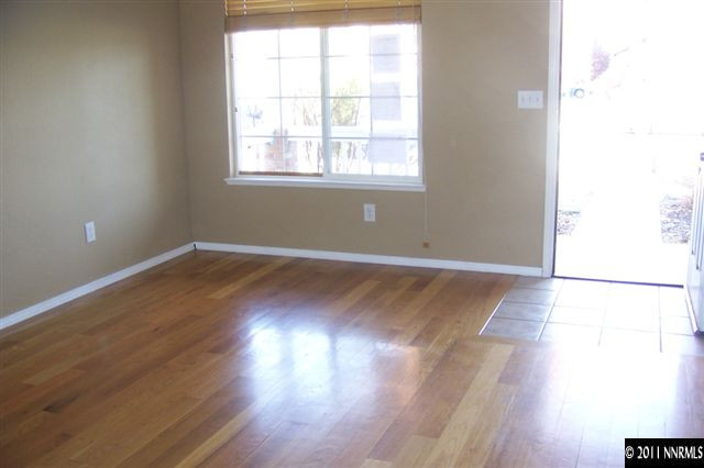 1700 Northrup Court Reno, NV 89521 - Photo 3 of 11 an empty room with wooden floor and windows