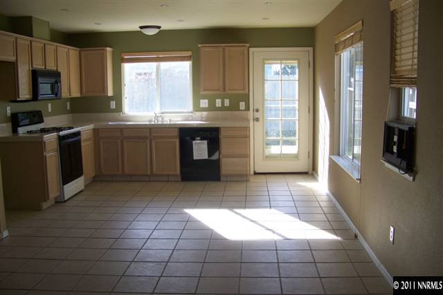 1700 Northrup Court Reno, NV 89521 - Photo 5 of 11 a kitchen with stainless steel appliances granite countertop a stove a sink and a microwave