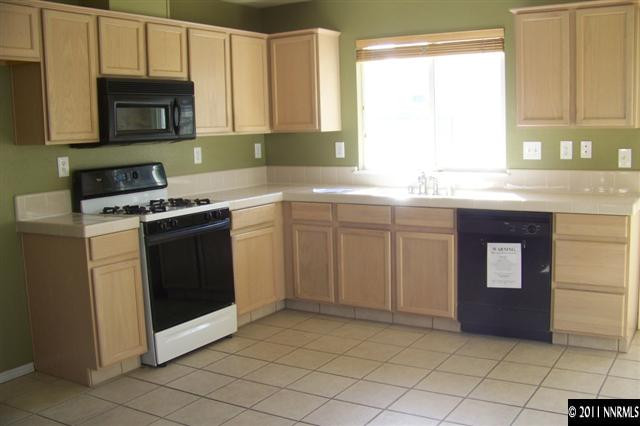 1700 Northrup Court Reno, NV 89521 - Photo 6 of 11 a kitchen with stainless steel appliances granite countertop a stove a sink and a microwave