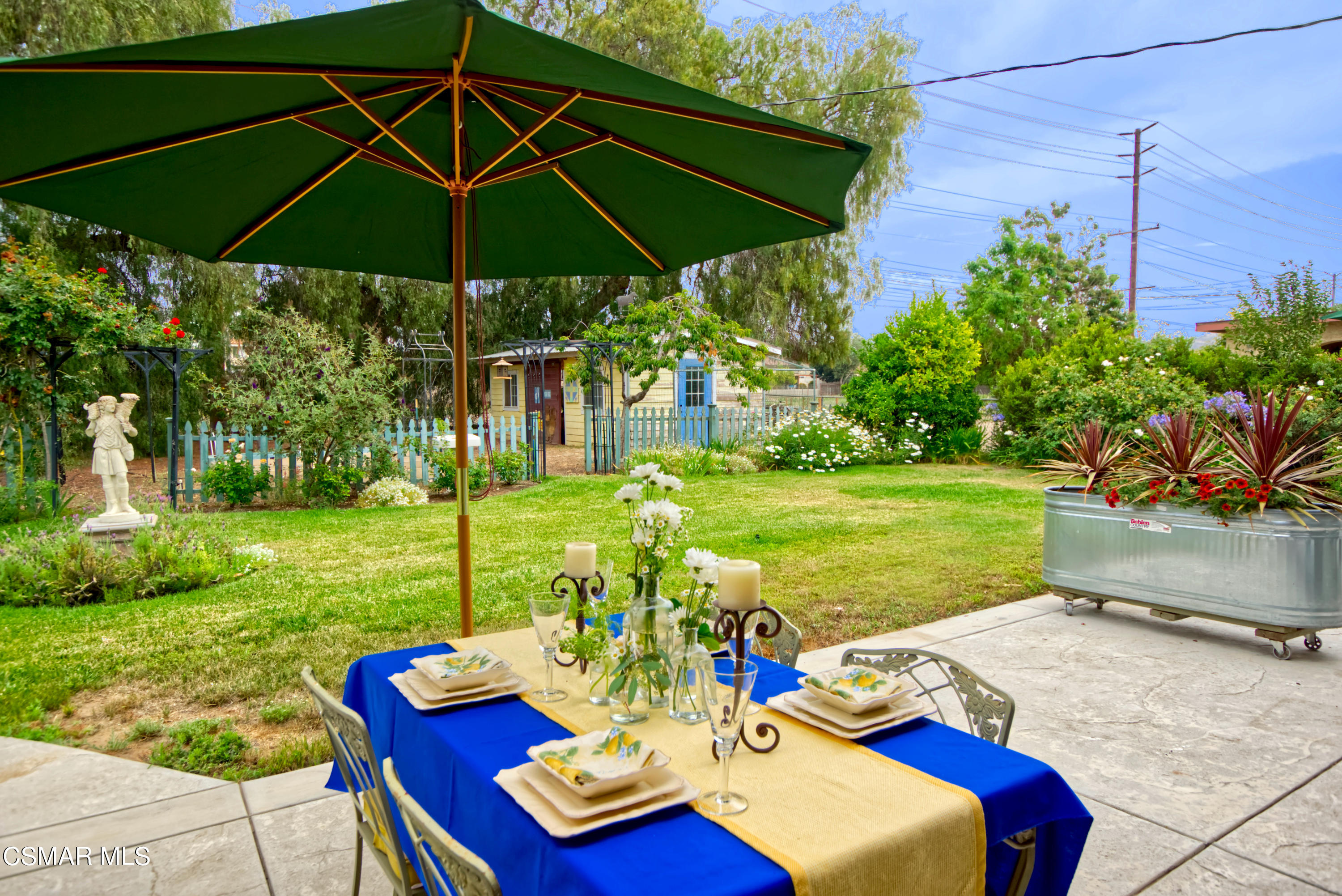 4888 Mira Sol Drive Moorpark, CA 93021 - Photo 35 of 39 a view of a patio with chairs under an umbrella