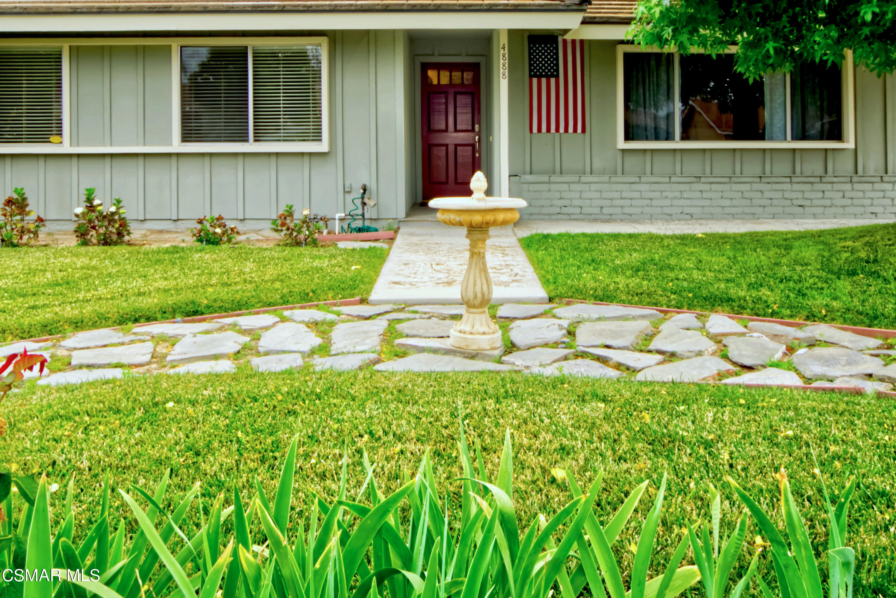 4888 Mira Sol Drive Moorpark, CA 93021 - Photo 6 of 39 a front view of a house with a yard and porch