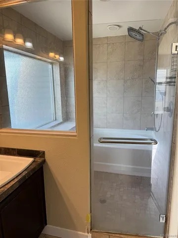 a bathroom with a bathtub and shower