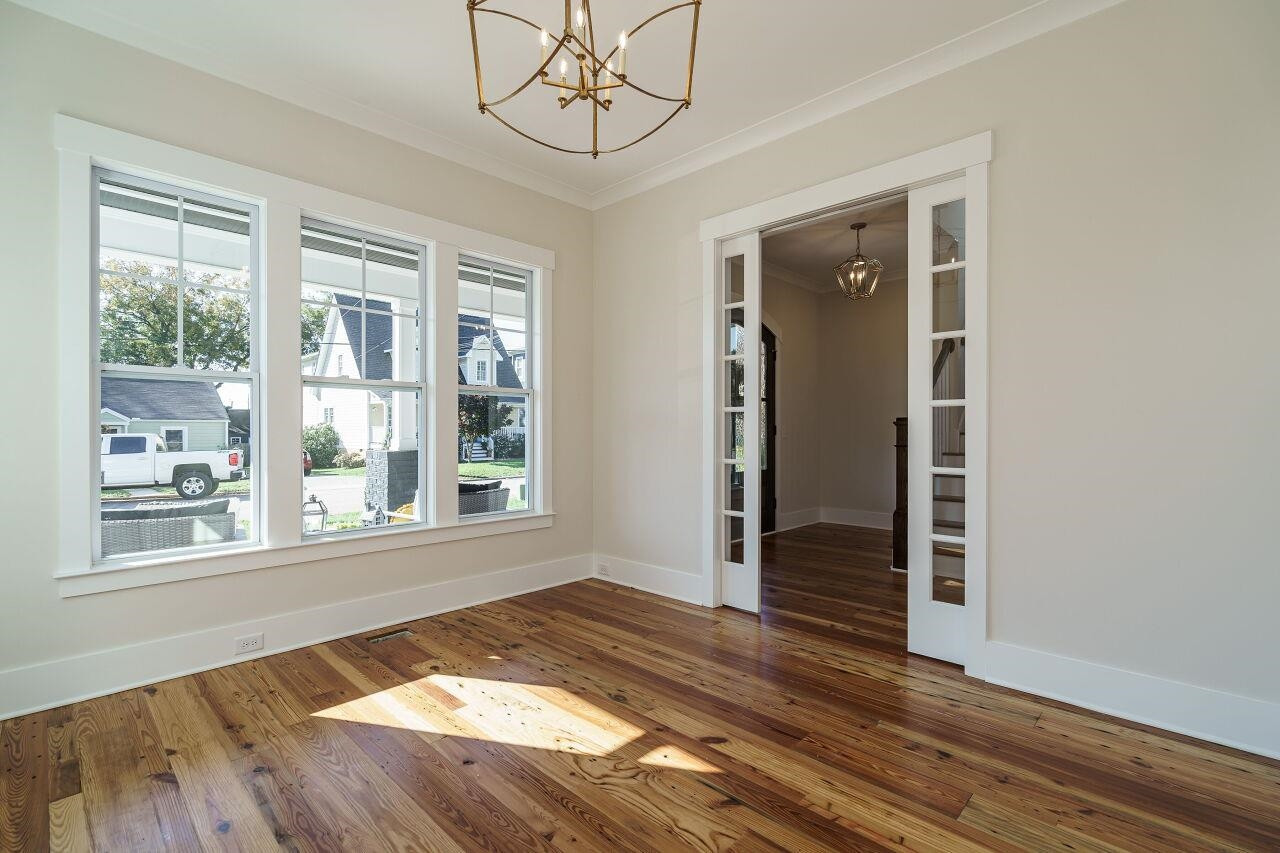 213 Georgetown Road Raleigh, NC 27608 - Photo 11 of 44 a view of empty room with wooden floor and fan