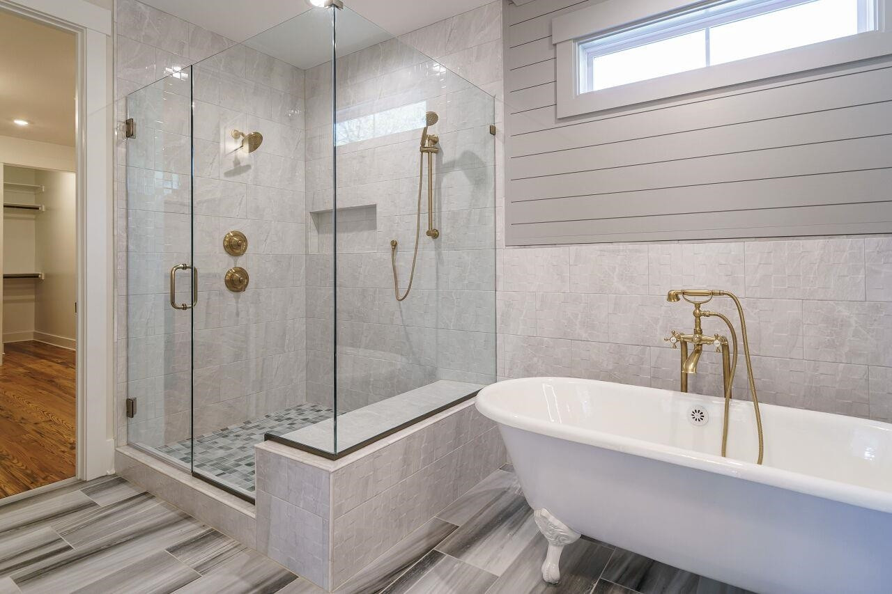 213 Georgetown Road Raleigh, NC 27608 - Photo 16 of 44 a bathroom with a bathtub and a shower
