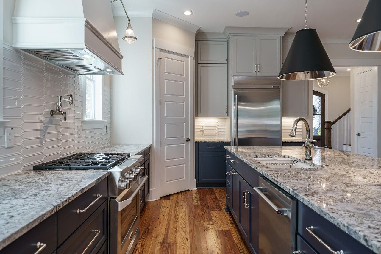 213 Georgetown Road Raleigh, NC 27608 - Photo 2 of 44 a kitchen with stainless steel appliances granite countertop a sink stove and refrigerator