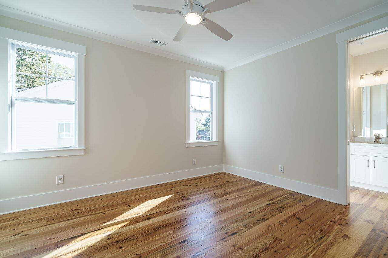 213 Georgetown Road Raleigh, NC 27608 - Photo 22 of 44 a view of an empty room with wooden floor and a window
