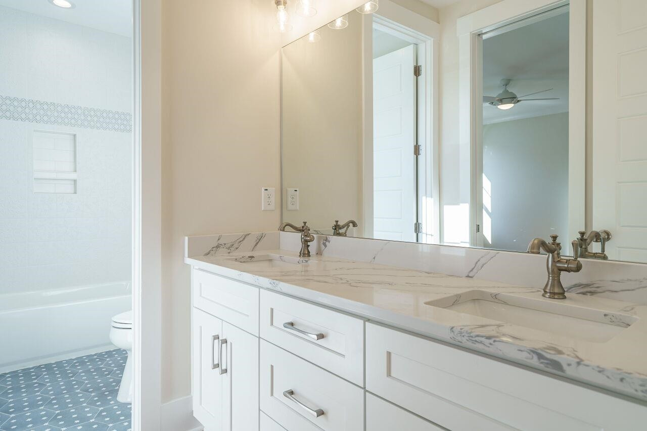 213 Georgetown Road Raleigh, NC 27608 - Photo 25 of 44 a bathroom with double sink and a mirror