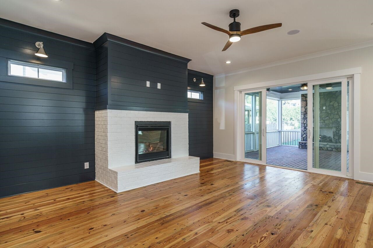 213 Georgetown Road Raleigh, NC 27608 - Photo 6 of 44 a view of an empty room with window and wooden floor