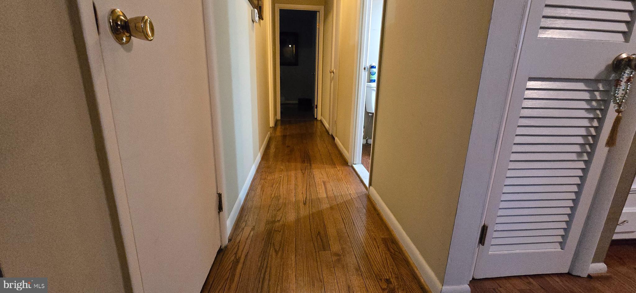 11507 Keystone Avenue Clinton, MD 20735 - Photo 15 of 33 a view of a hallway with wooden floor and staircase