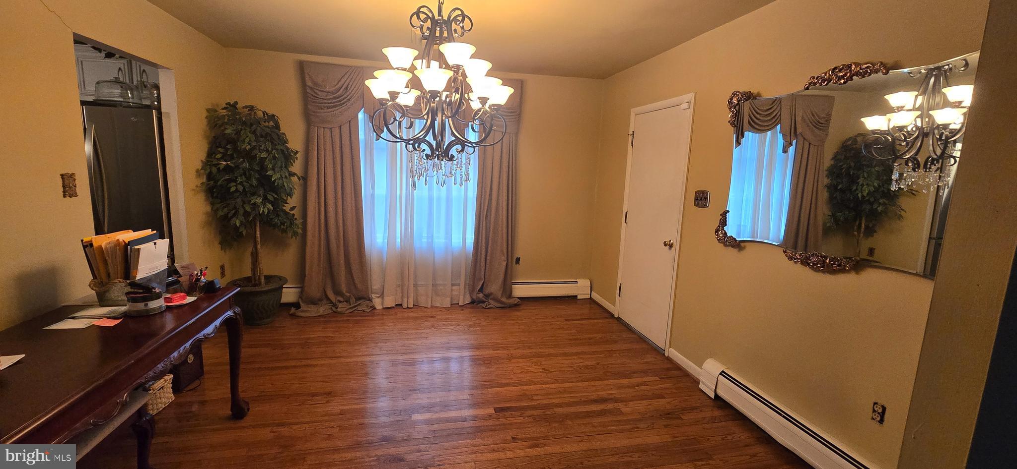 11507 Keystone Avenue Clinton, MD 20735 - Photo 16 of 33 a view of a hallway with wooden floor and a chandelier