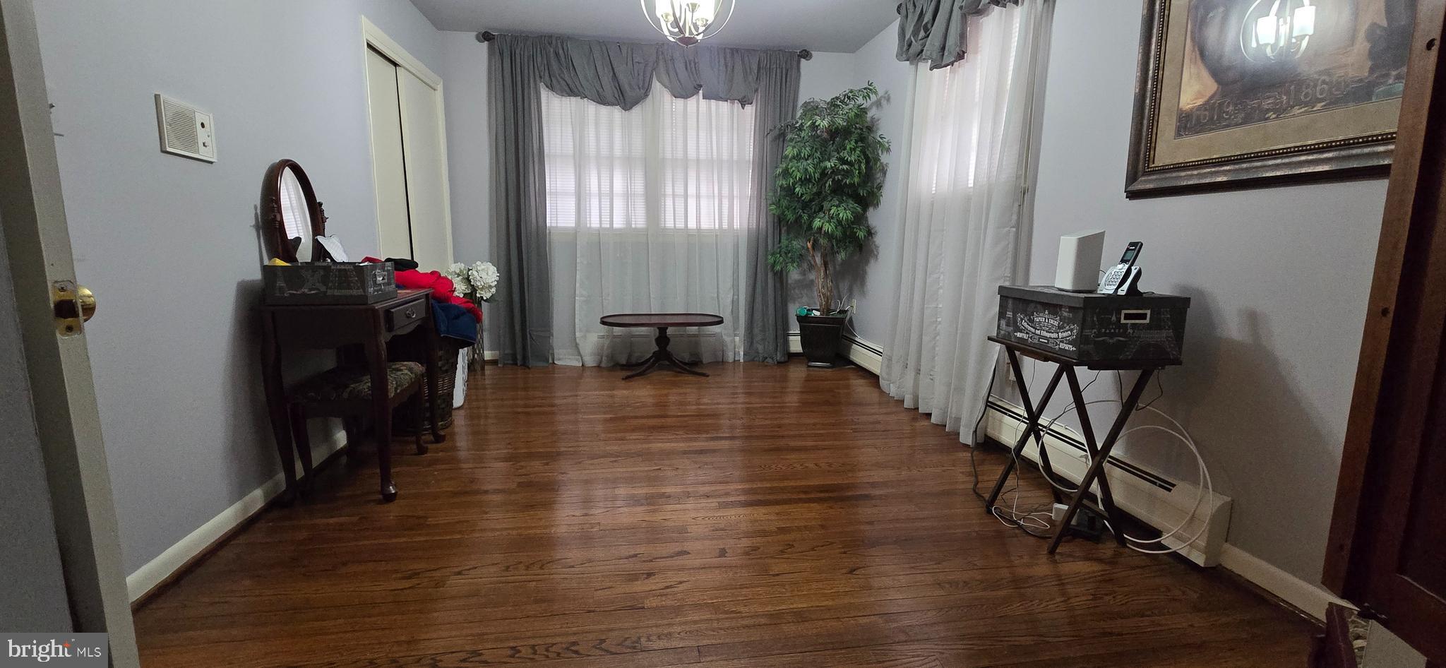 11507 Keystone Avenue Clinton, MD 20735 - Photo 19 of 33 a view of a hallway with wooden floor and furniture