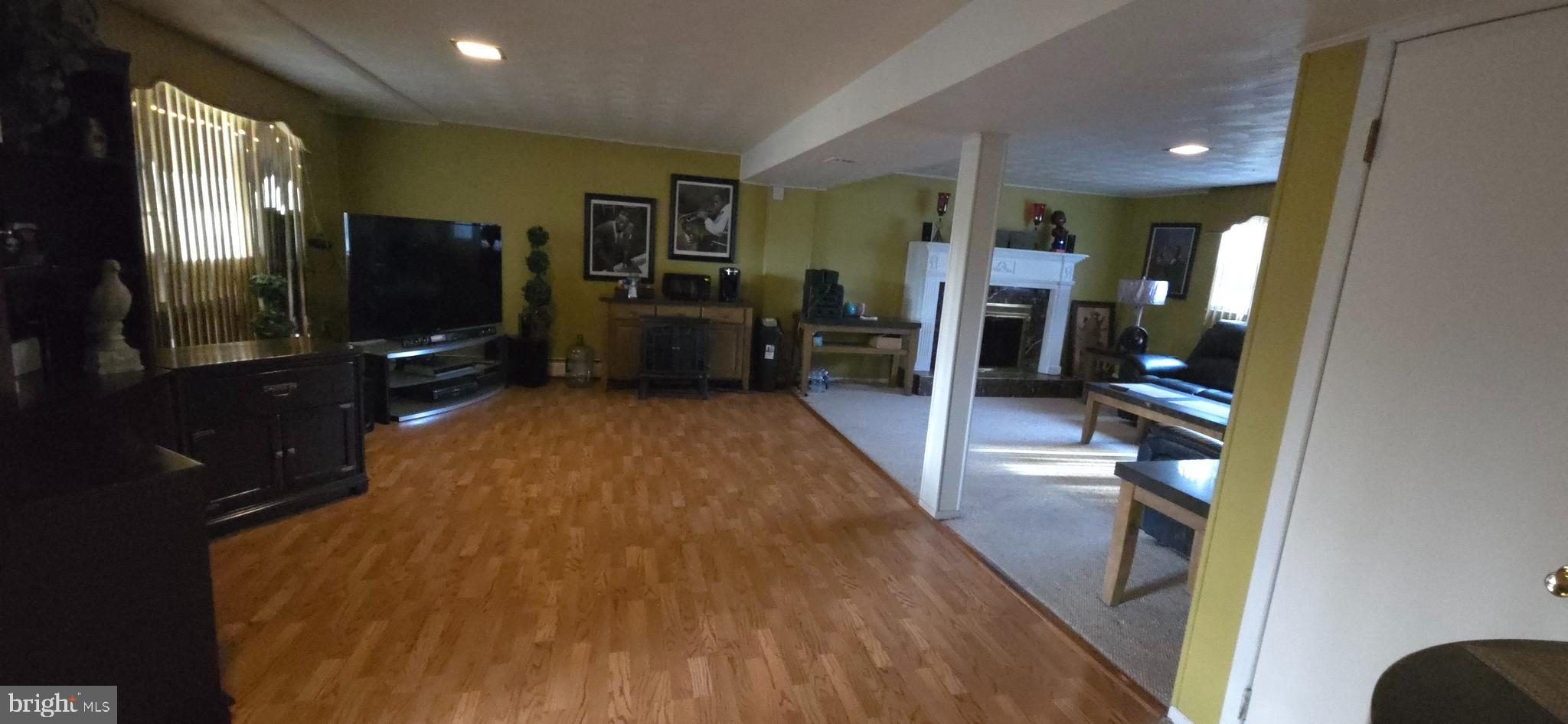11507 Keystone Avenue Clinton, MD 20735 - Photo 24 of 33 a living room with stainless steel appliances furniture a flat screen tv and a table