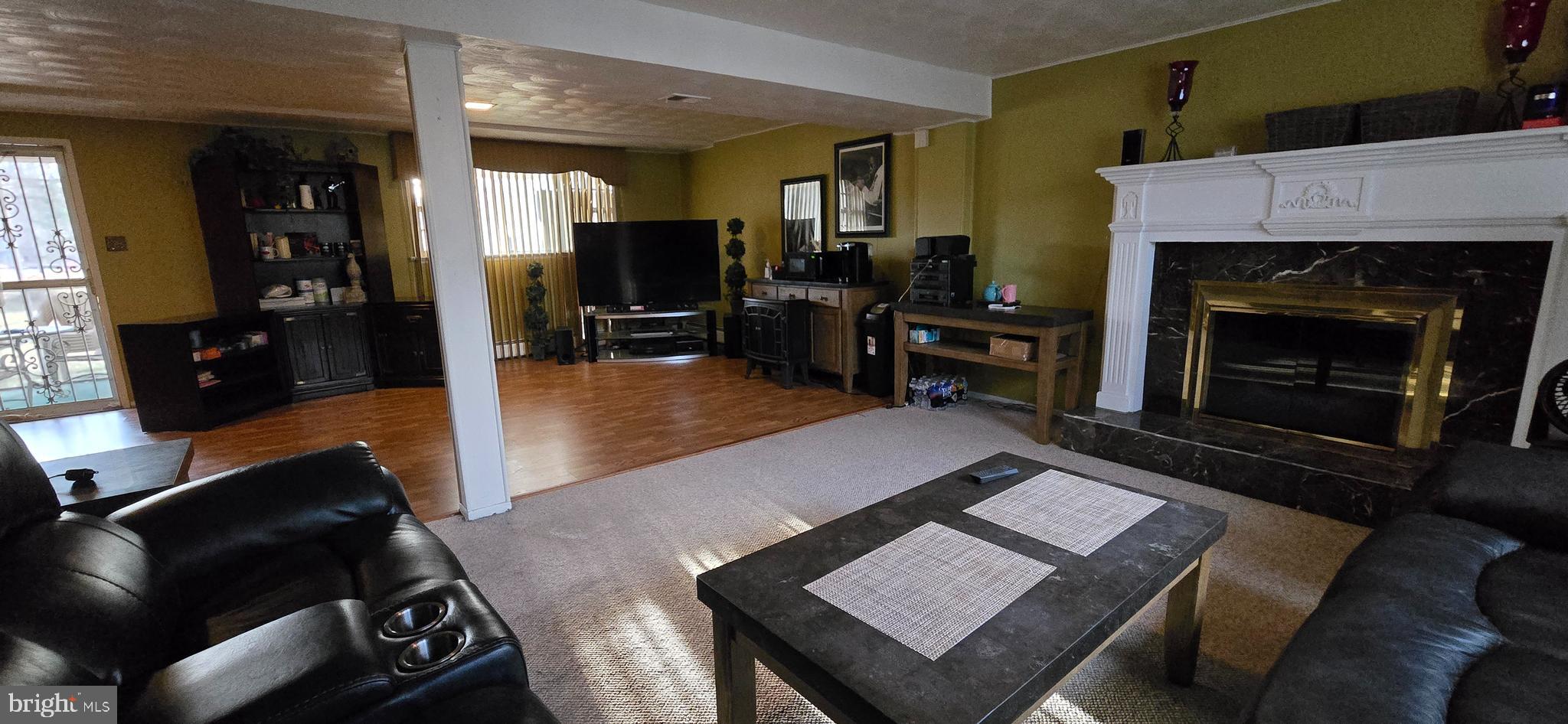 11507 Keystone Avenue Clinton, MD 20735 - Photo 26 of 33 a living room with furniture and a fireplace
