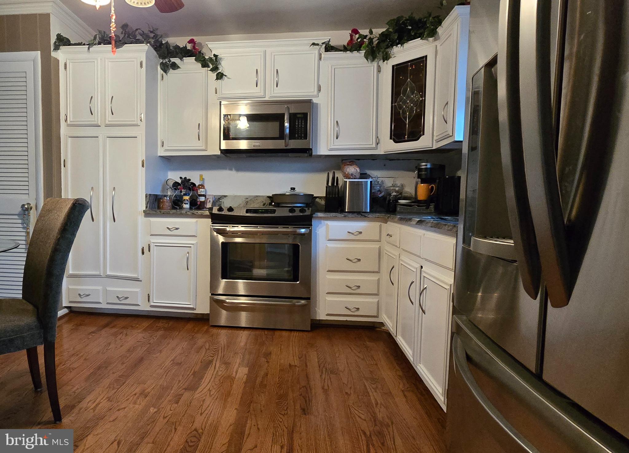 11507 Keystone Avenue Clinton, MD 20735 - Photo 8 of 33 a kitchen with stainless steel appliances a stove microwave and a refrigerator
