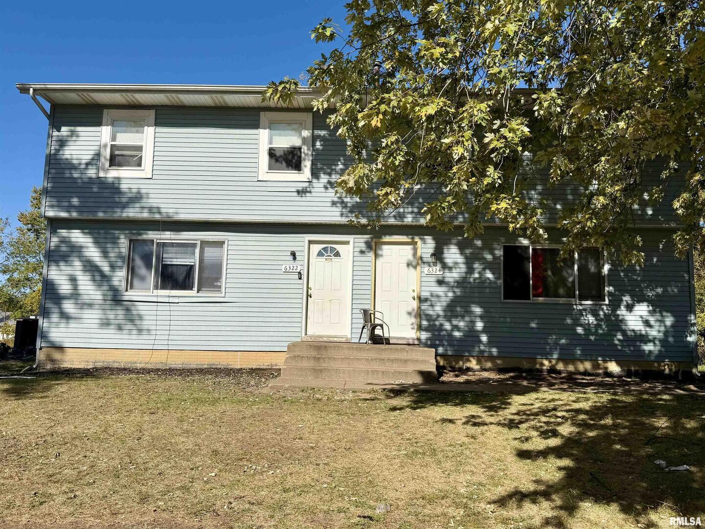 a house that has a tree in front of it