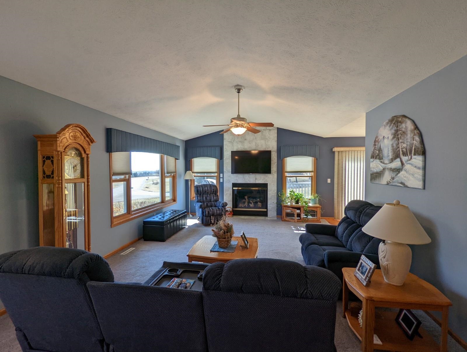 2009 Baintree Road Lake Summerset, IL 61019 - Photo 7 of 30 a living room with furniture a fireplace and a chandelier