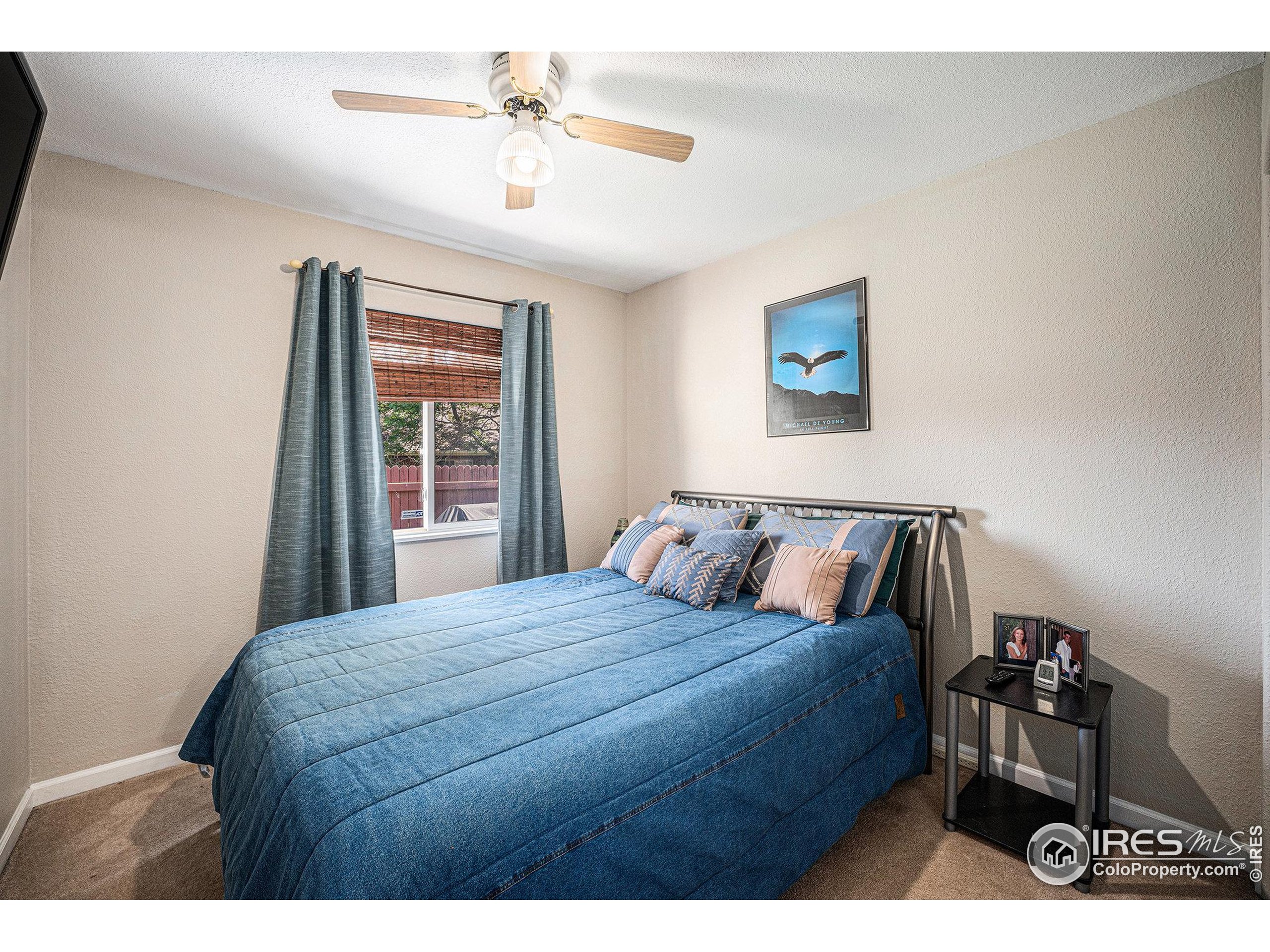 1030 South Fulton Avenue Fort Lupton, CO 80621 - Photo 11 of 26 a bedroom with a bed a dresser and a window