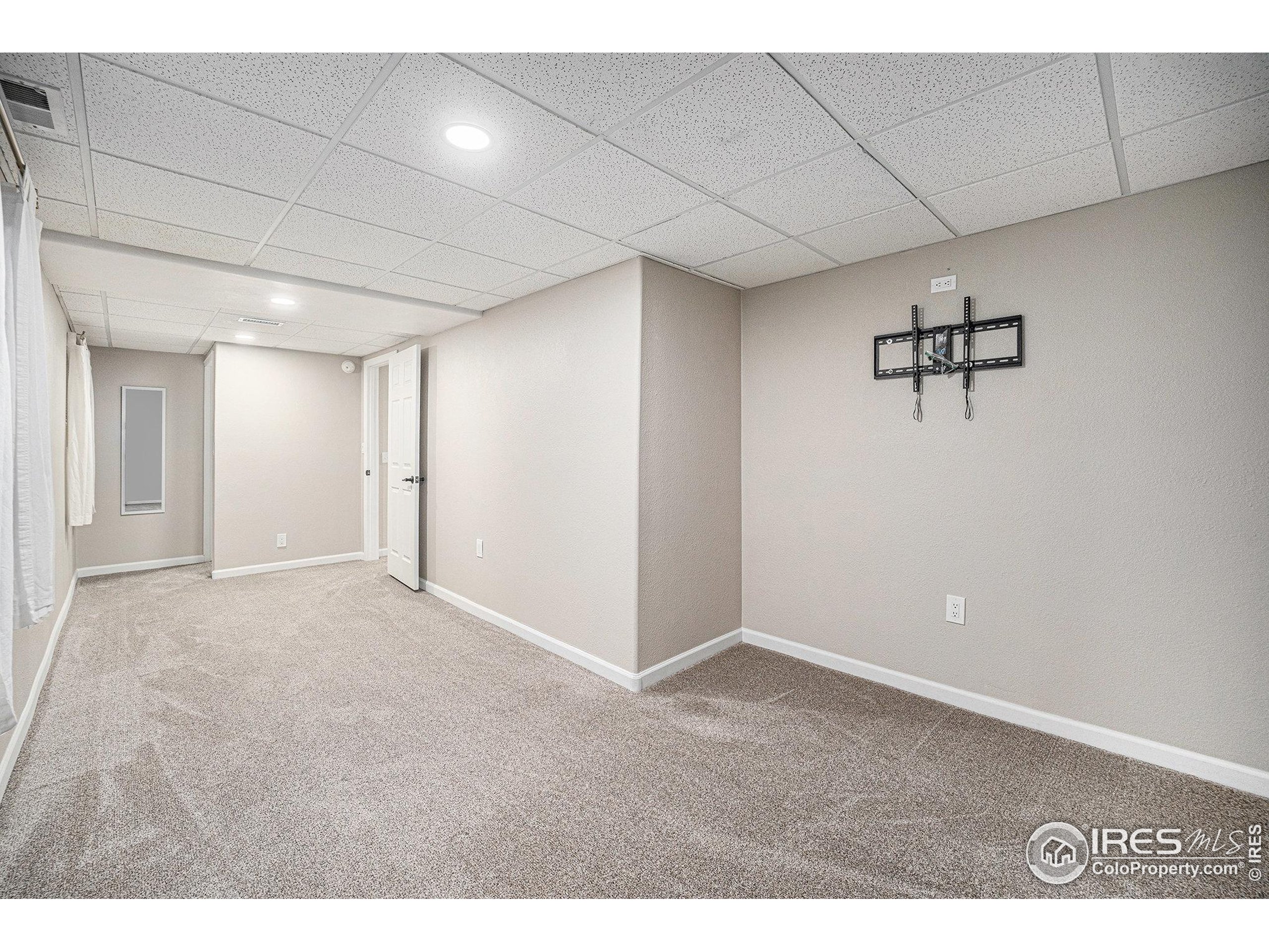 1030 South Fulton Avenue Fort Lupton, CO 80621 - Photo 14 of 26 a view of a room with a projector