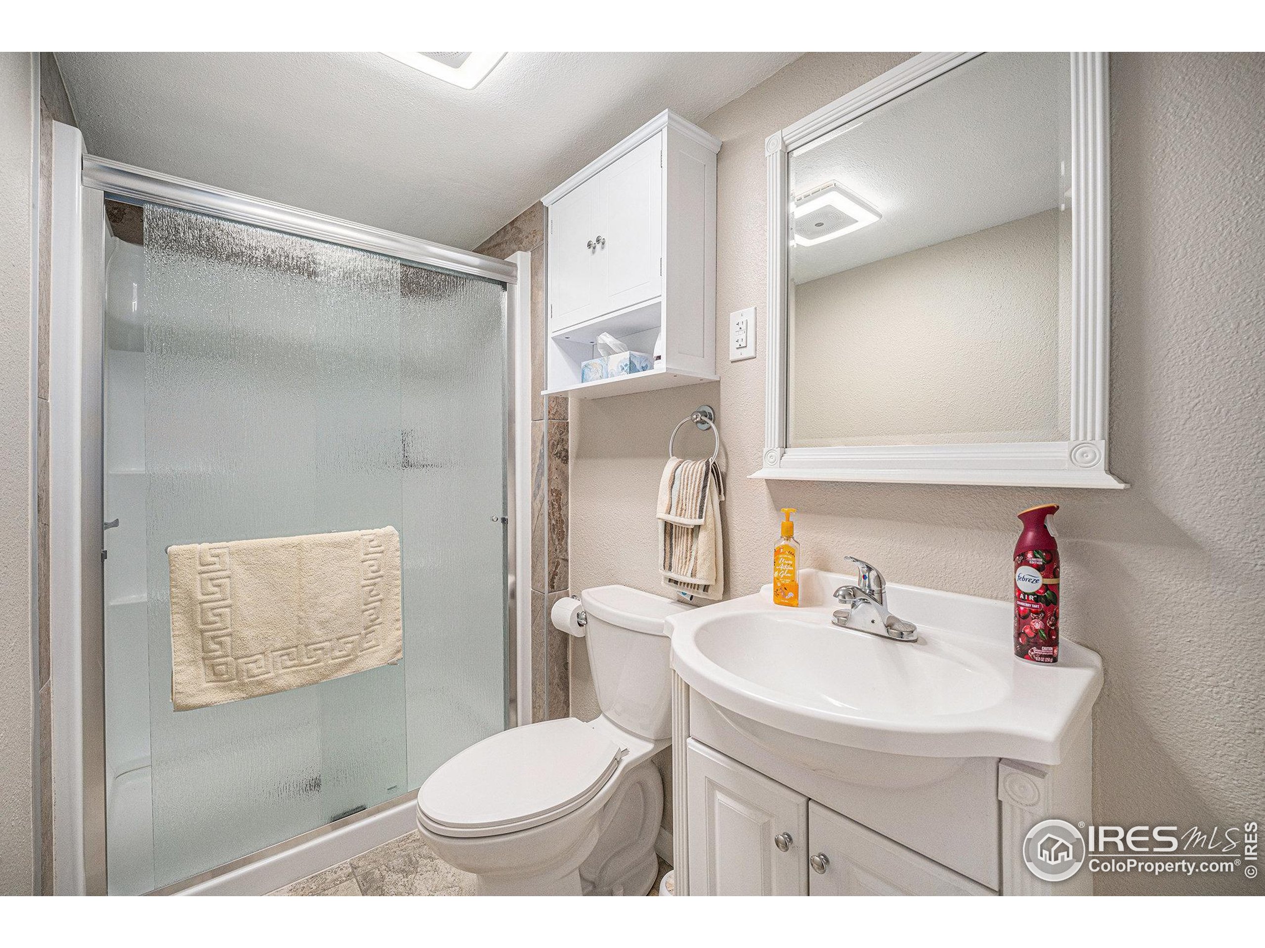 1030 South Fulton Avenue Fort Lupton, CO 80621 - Photo 15 of 26 a bathroom with a sink toilet and shower