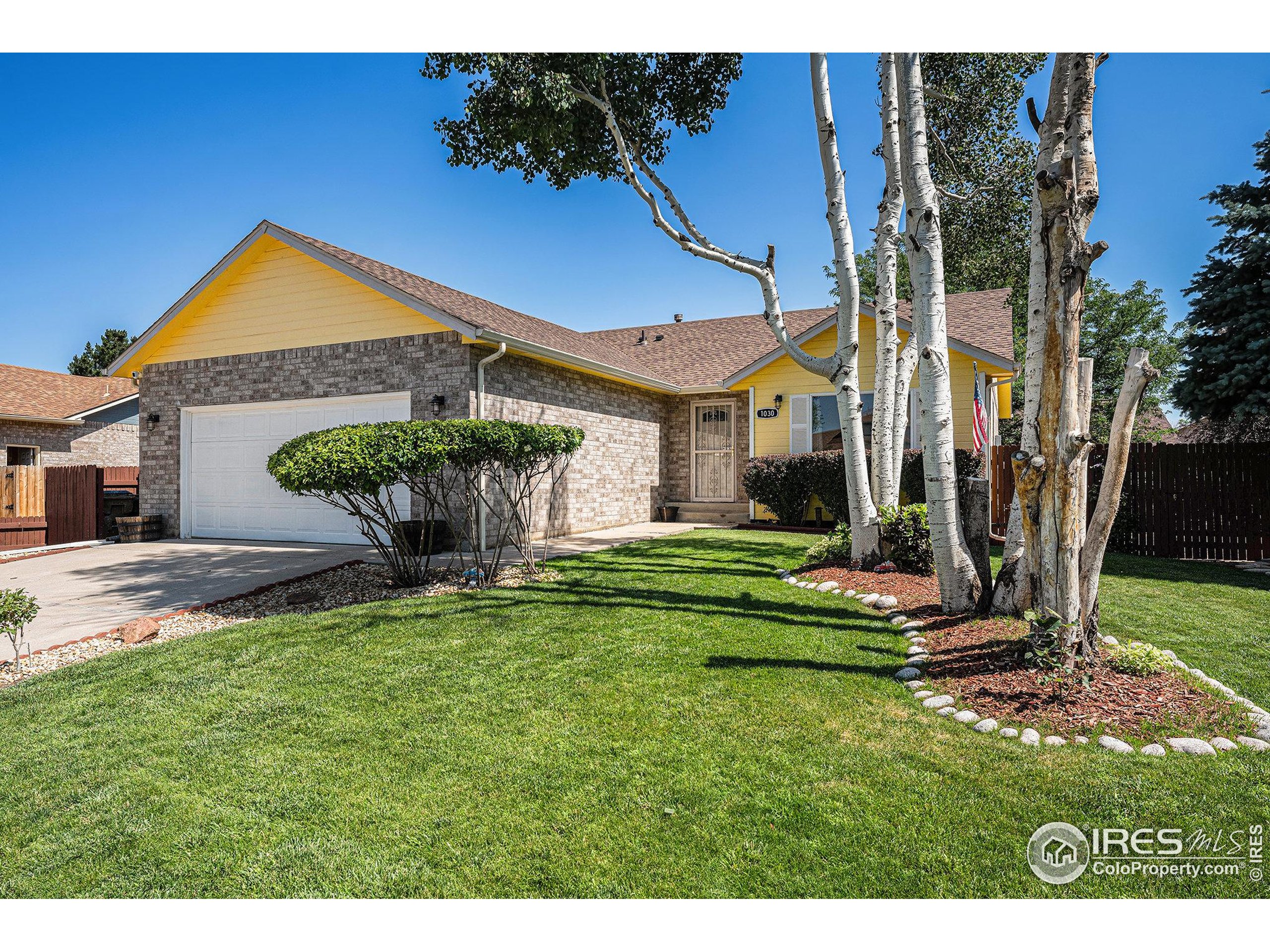 1030 South Fulton Avenue Fort Lupton, CO 80621 - Photo 2 of 26 a front view of a house with garden
