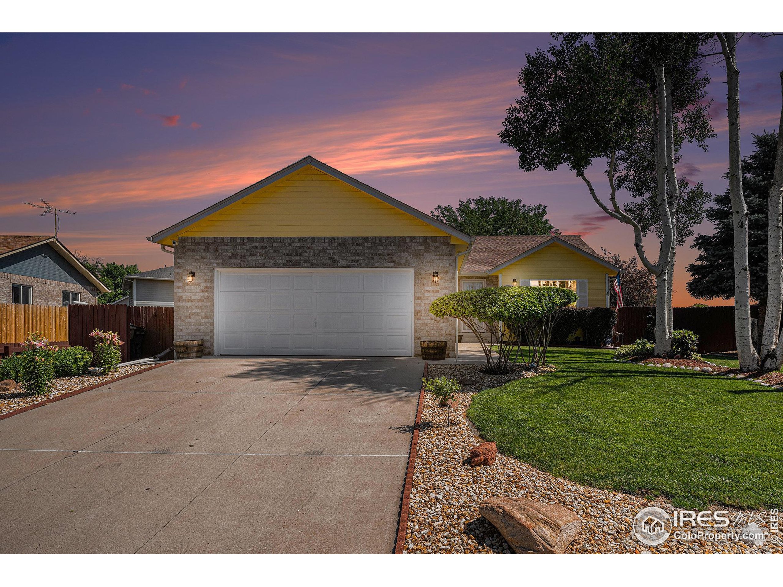 1030 South Fulton Avenue Fort Lupton, CO 80621 - Photo 3 of 26 a front view of a house with a yard and garage