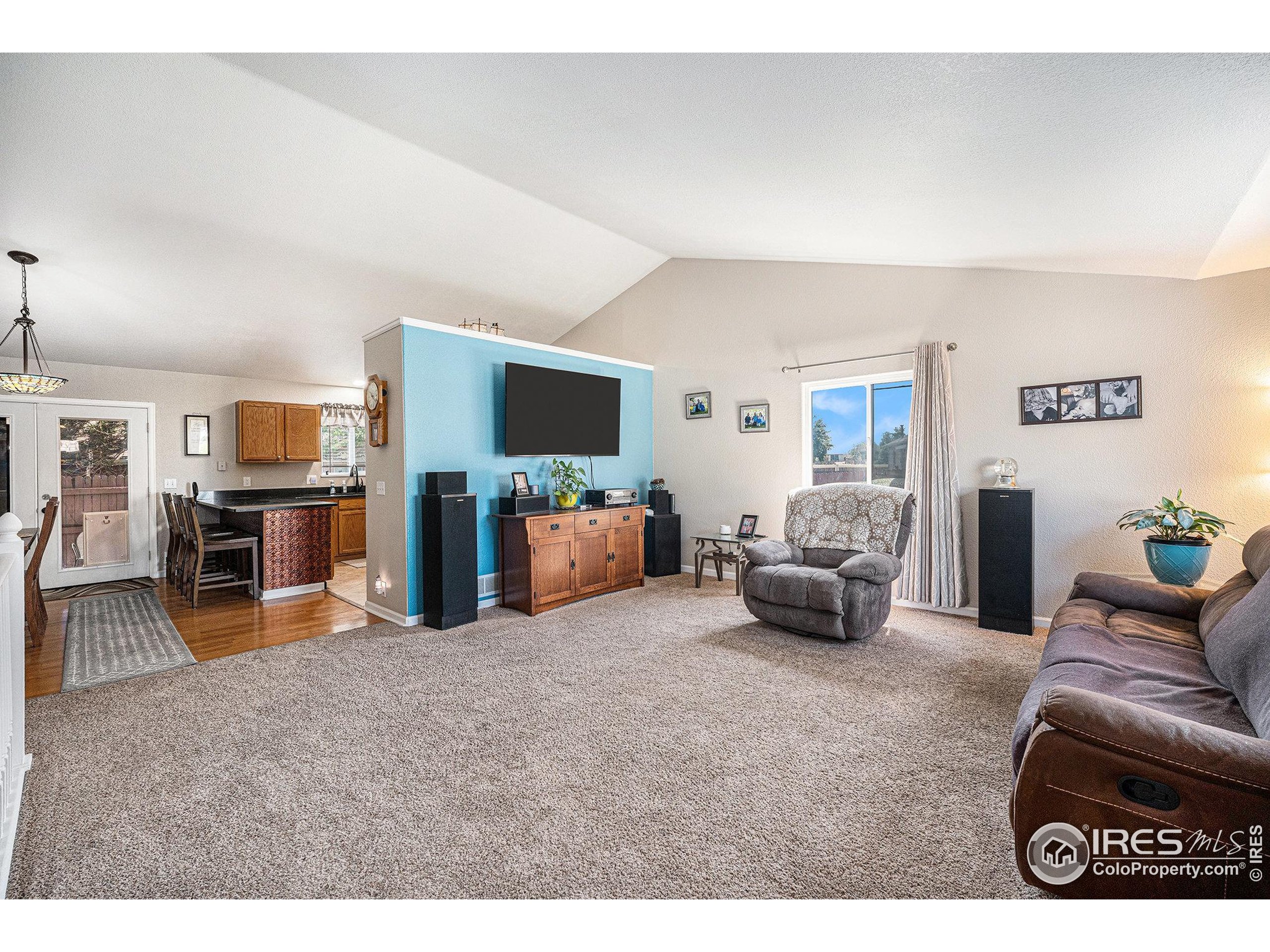 1030 South Fulton Avenue Fort Lupton, CO 80621 - Photo 5 of 26 a living room with furniture and a flat screen tv