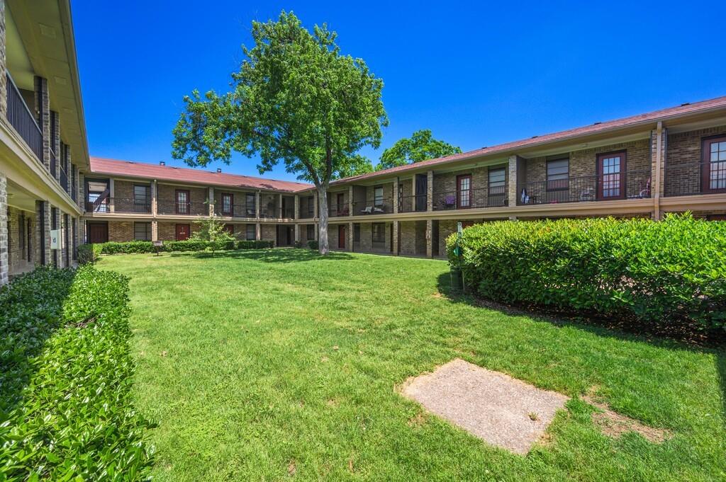 a view of a house with a yard and sitting area