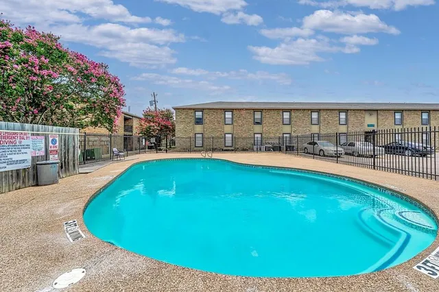 a view of a park with a bench and trees