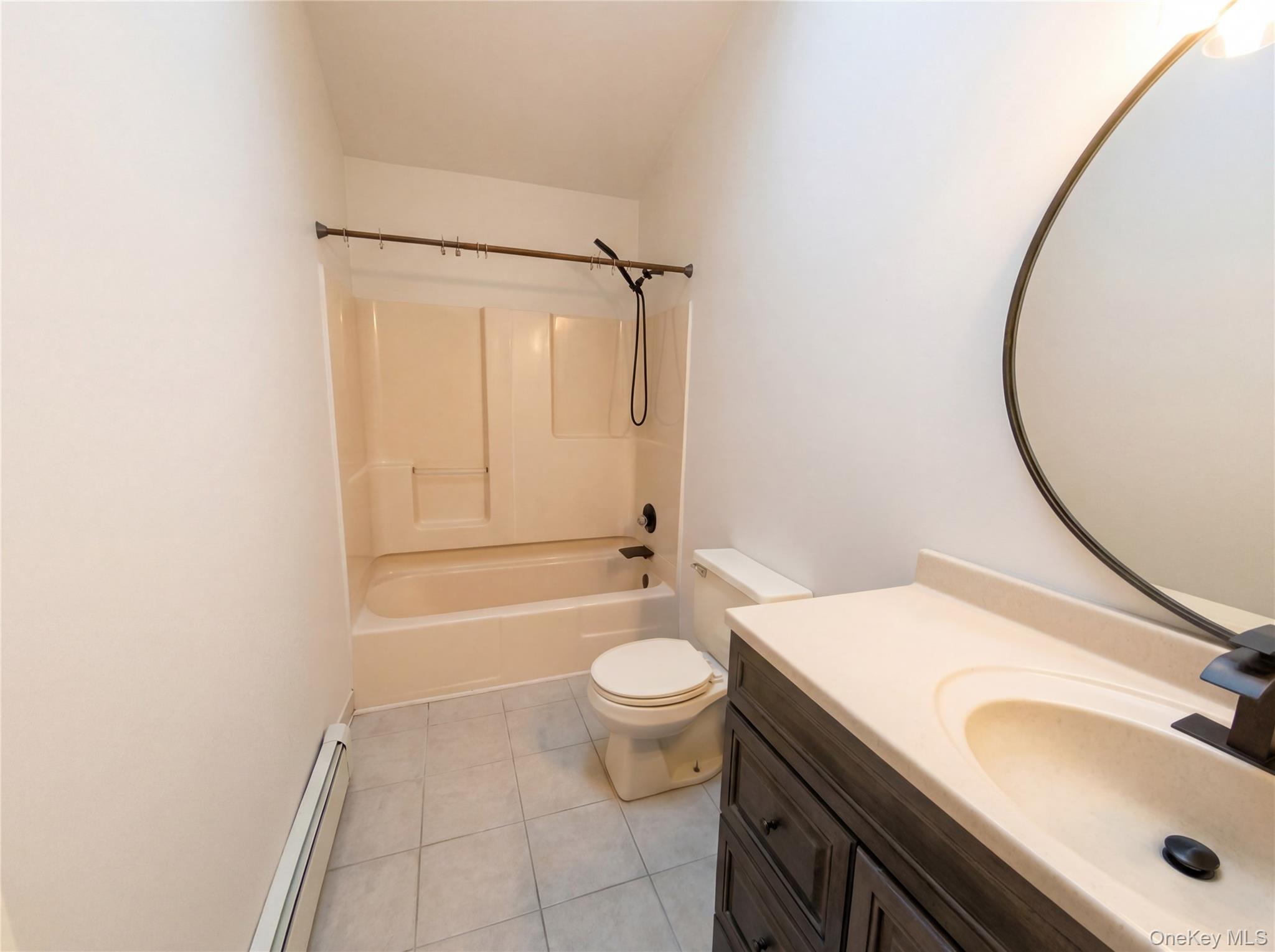 269 Prince Road Brookhaven, NY 11778 - Photo 11 of 22 a bathroom with a sink and a mirror