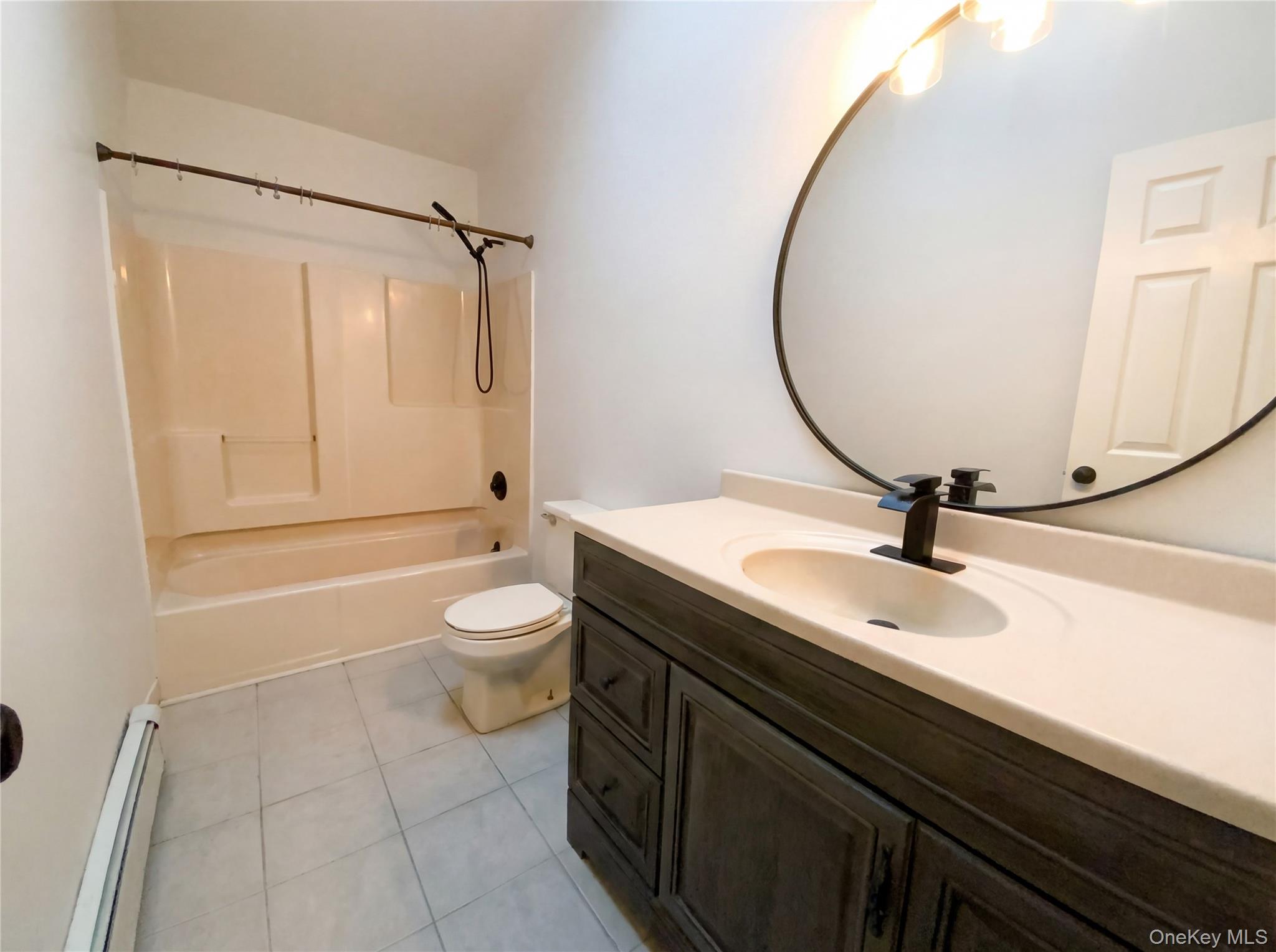 269 Prince Road Brookhaven, NY 11778 - Photo 12 of 22 a bathroom with a sink a toilet and a mirror