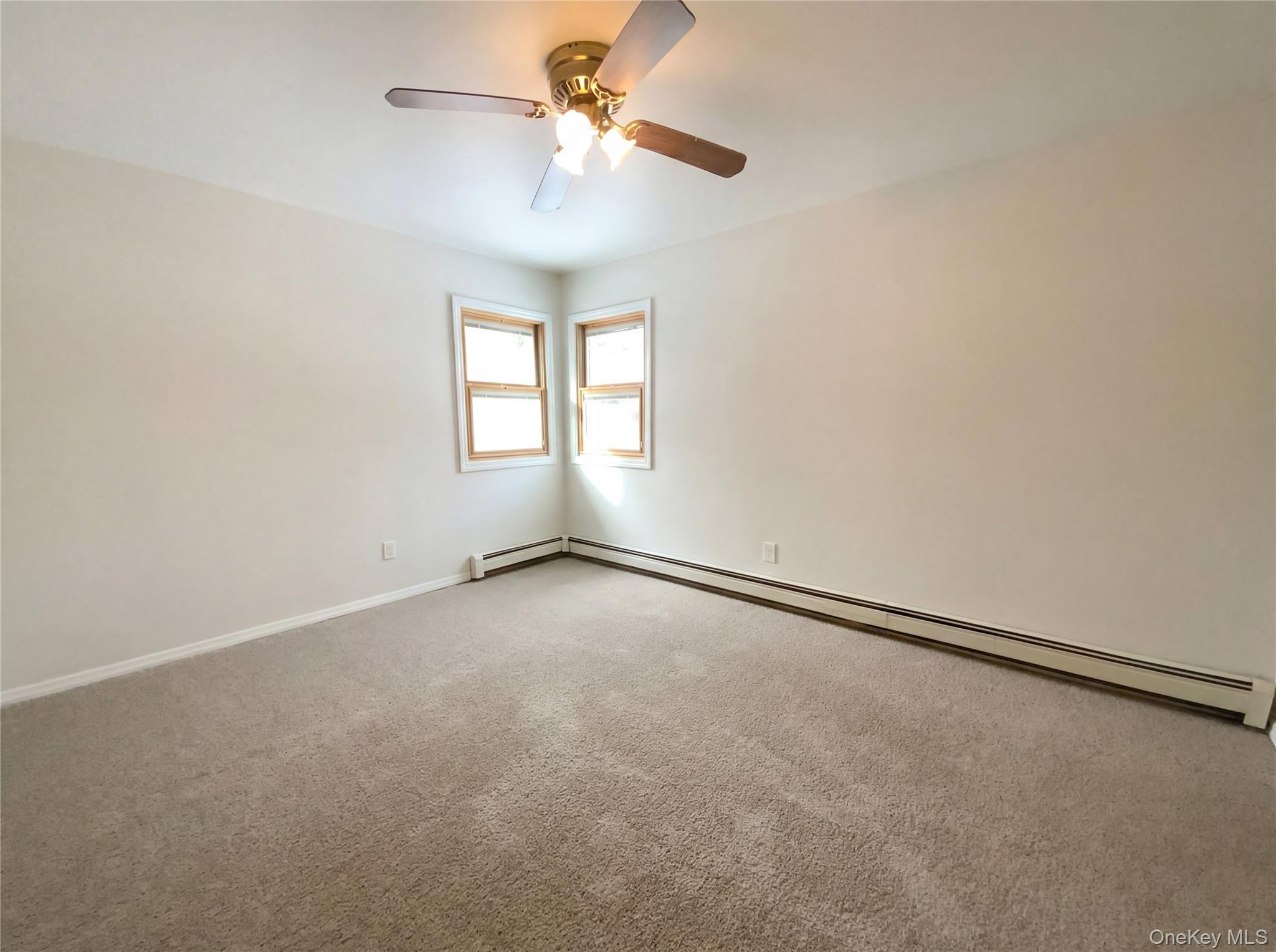 269 Prince Road Brookhaven, NY 11778 - Photo 13 of 22 wooden floor in an empty room with a window