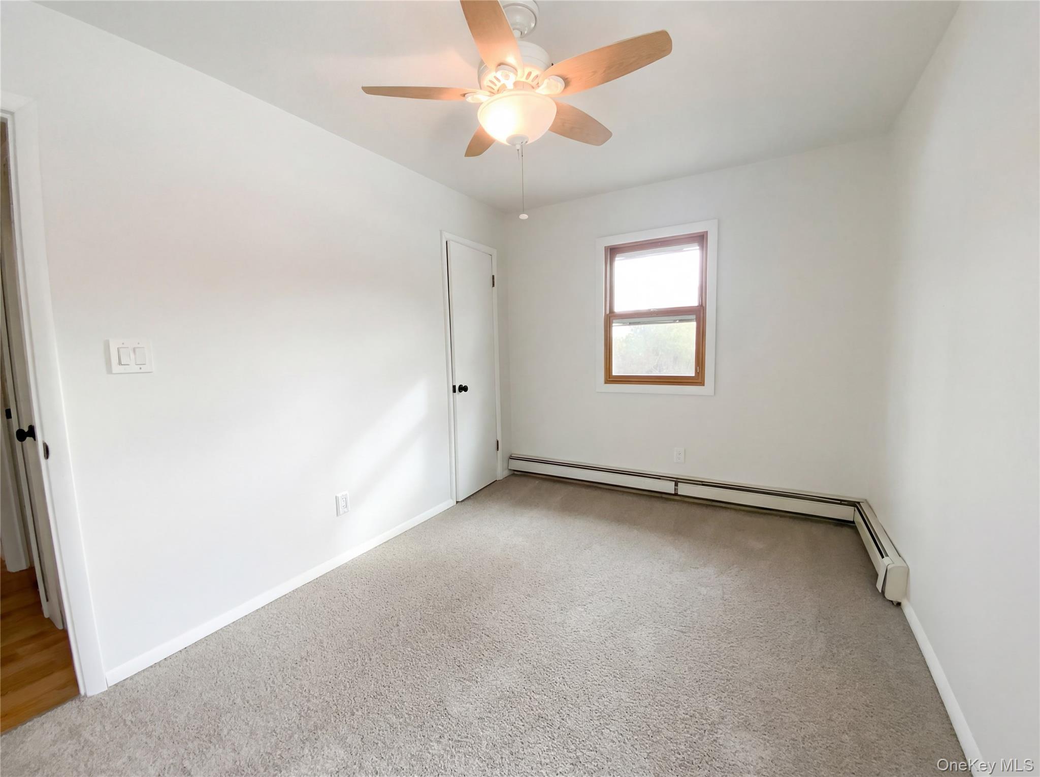 269 Prince Road Brookhaven, NY 11778 - Photo 15 of 22 an empty room with a window and a fan
