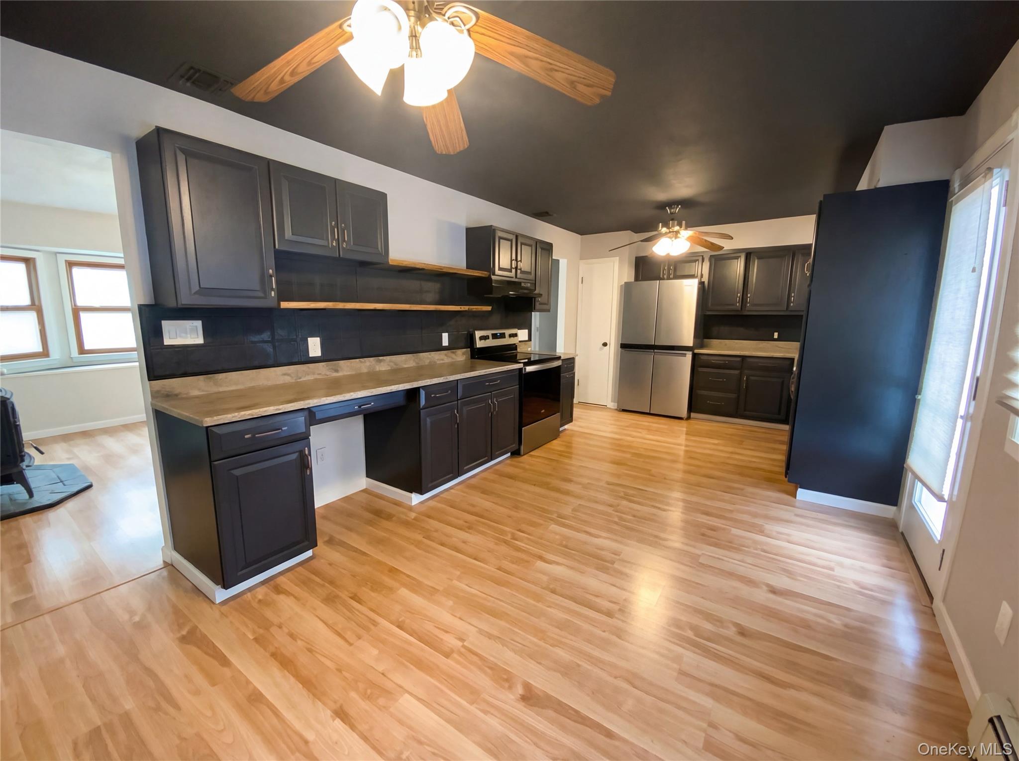 269 Prince Road Brookhaven, NY 11778 - Photo 2 of 22 a large kitchen with stainless steel appliances wooden cabinets and a counter top space