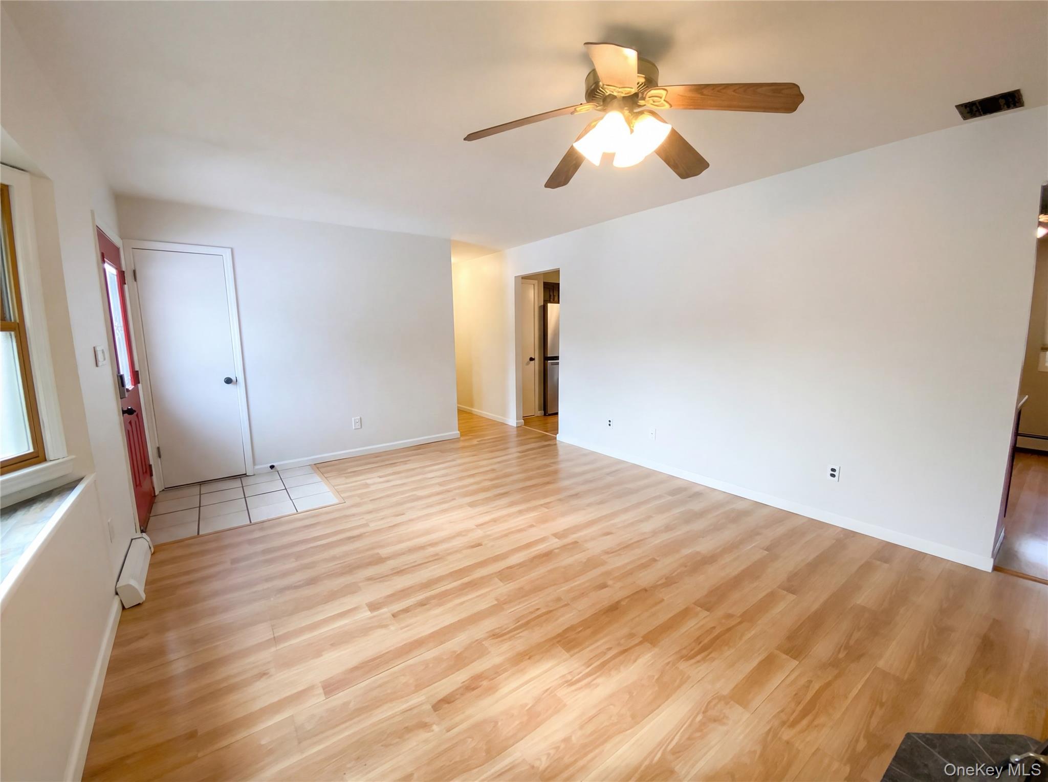 269 Prince Road Brookhaven, NY 11778 - Photo 6 of 22 a view of a room with wooden floor and a ceiling fan