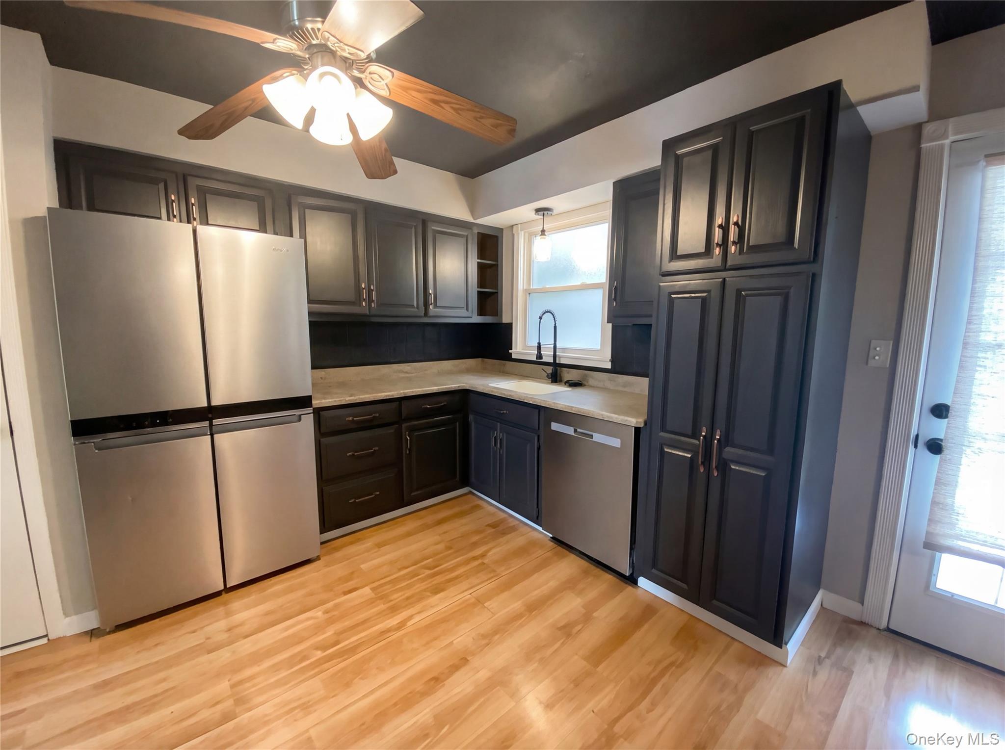 269 Prince Road Brookhaven, NY 11778 - Photo 7 of 22 a kitchen with granite countertop stainless steel appliances a refrigerator and a sink