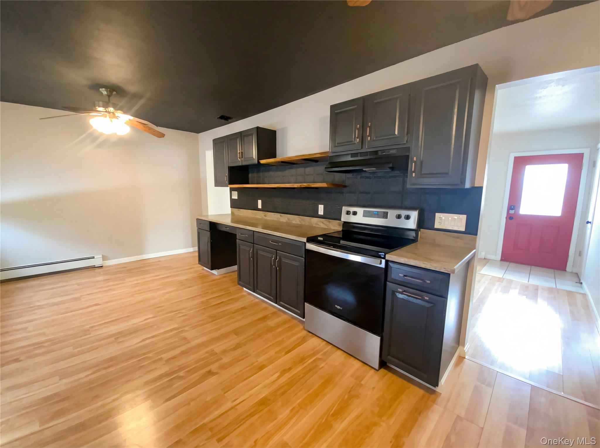 269 Prince Road Brookhaven, NY 11778 - Photo 8 of 22 a kitchen with stainless steel appliances kitchen island granite countertop a stove a sink and a microwave