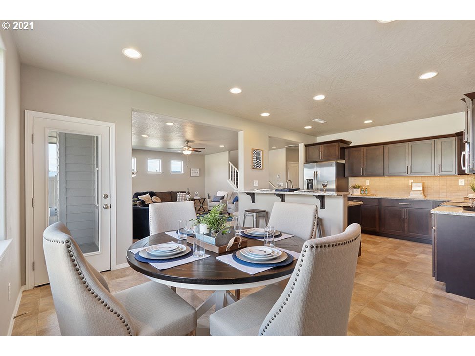 5021 Squirrel Street Springfield, OR 97478 - Photo 5 of 15 a kitchen with a dining table wooden floor and kitchen view
