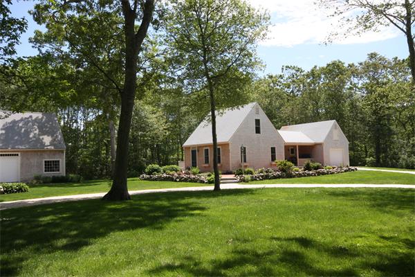 829 Division Road Westport, MA 02790 - Photo 1 of 15 a front view of house with a garden and trees