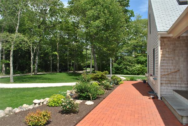 829 Division Road Westport, MA 02790 - Photo 3 of 15 a view of a backyard with potted plants and large trees