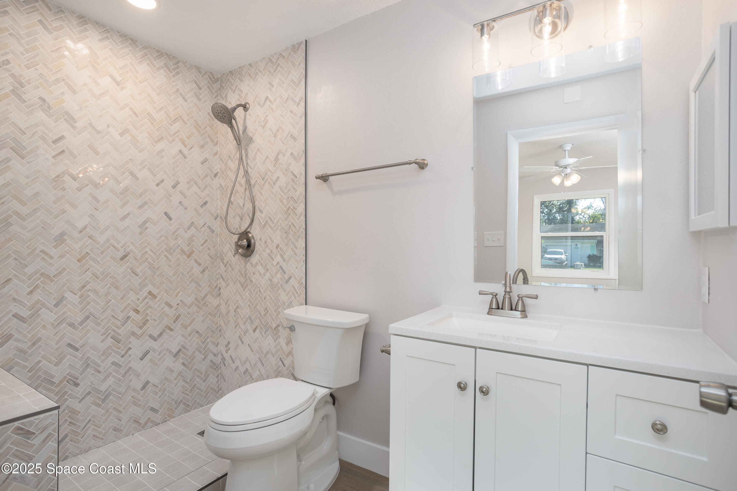 5446 Jamaica Road Cocoa, FL 32927 - Photo 13 of 21 a bathroom with a sink toilet and shower