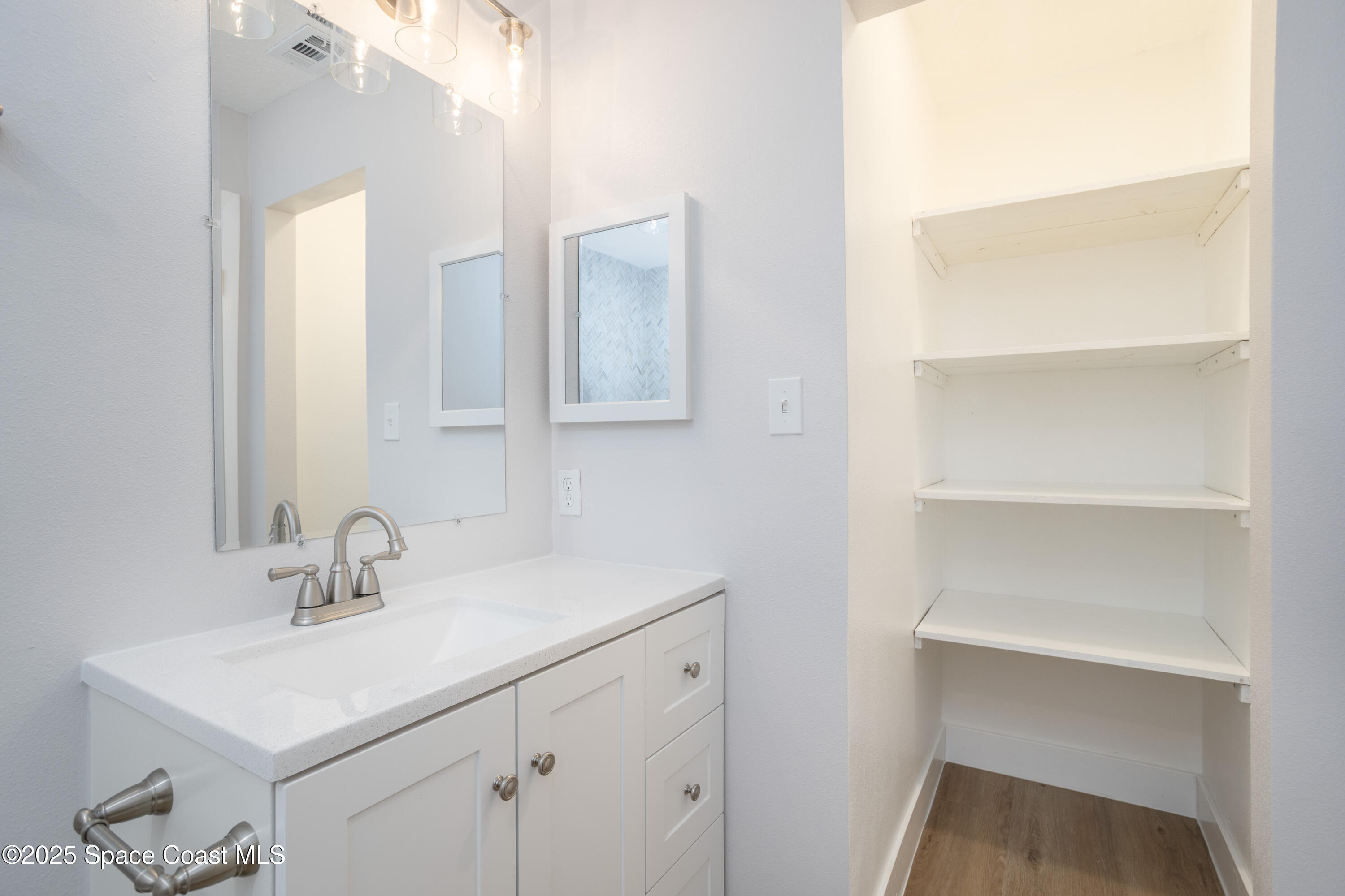 5446 Jamaica Road Cocoa, FL 32927 - Photo 14 of 21 a bathroom with a sink and a mirror