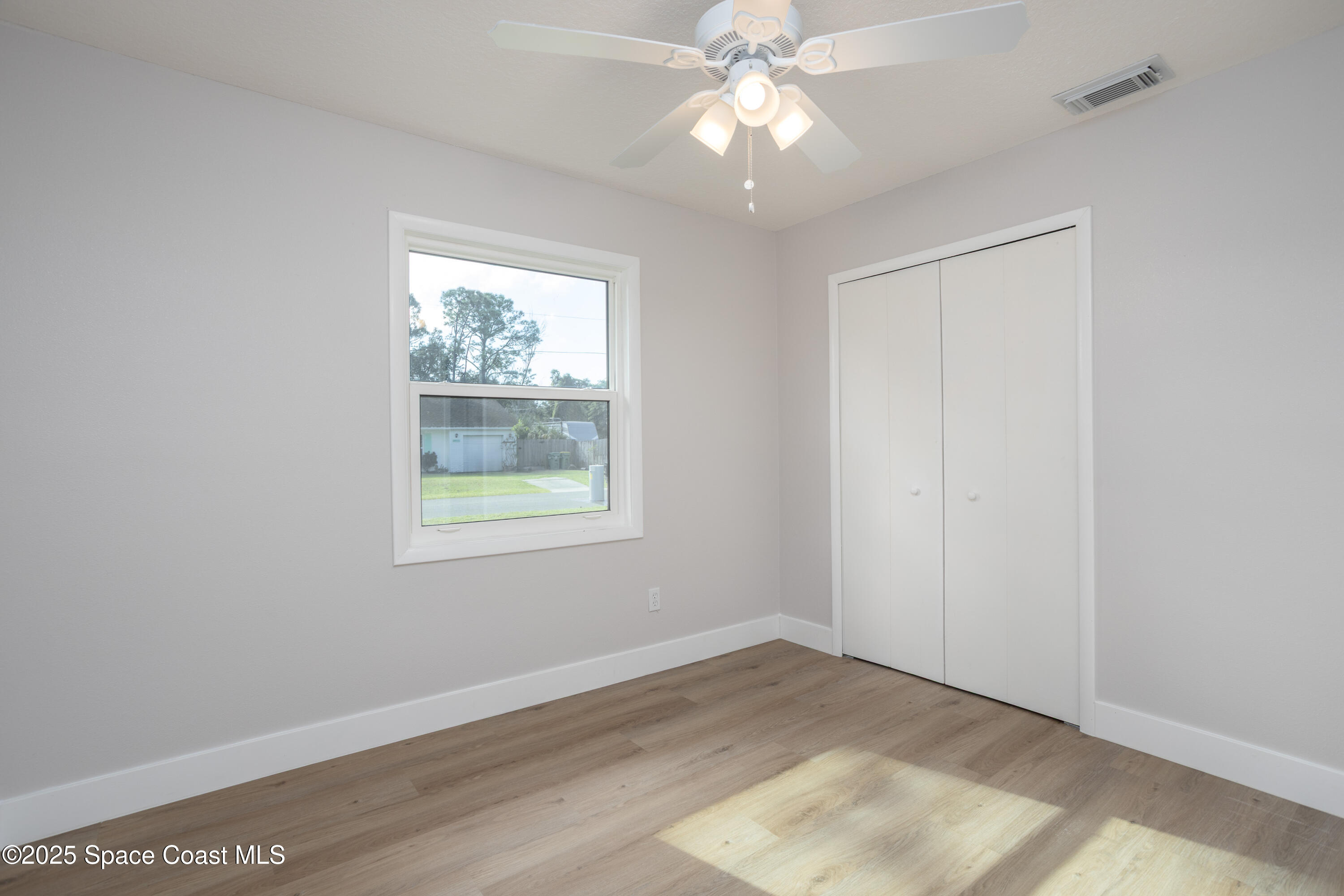 5446 Jamaica Road Cocoa, FL 32927 - Photo 15 of 21 an empty room with a window and a fan
