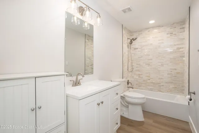 a bathroom with a sink toilet tub and shower