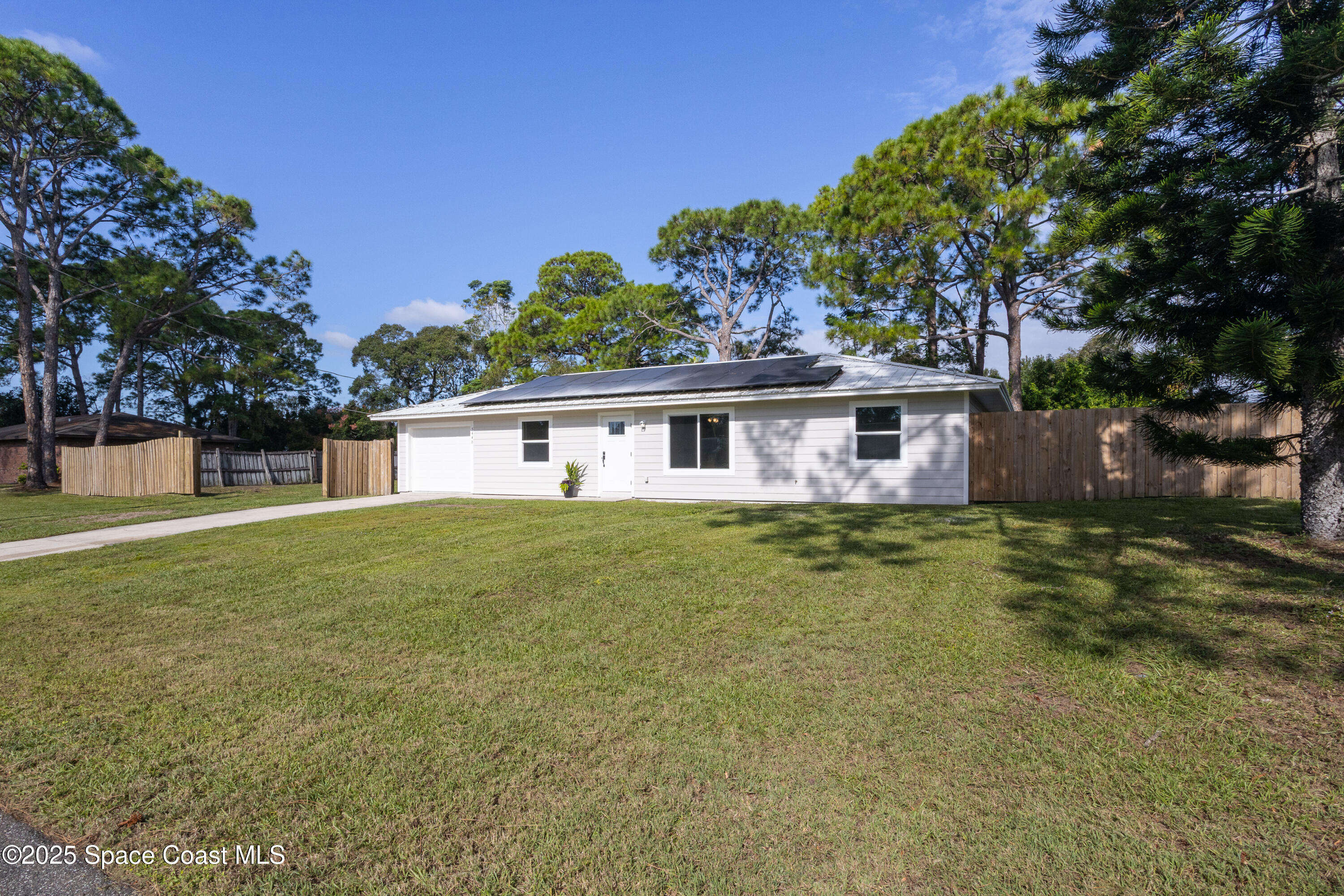 5446 Jamaica Road Cocoa, FL 32927 - Photo 2 of 21 a front view of a house with a garden
