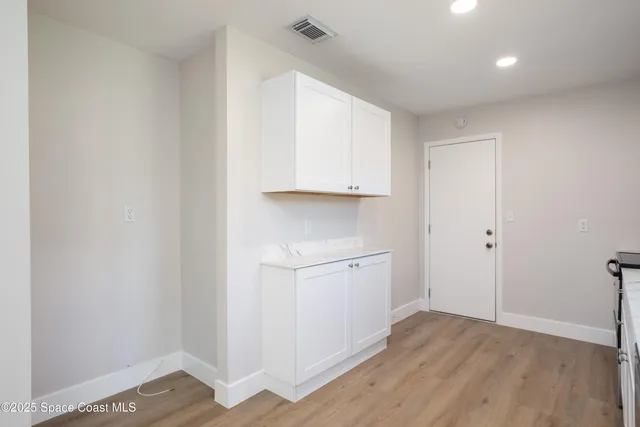 a view of cabinets and wooden floor