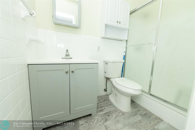 3515 Van Buren Street, Unit A Hollywood, FL 33021 - Photo 6 of 11 a bathroom with a toilet sink and vanity
